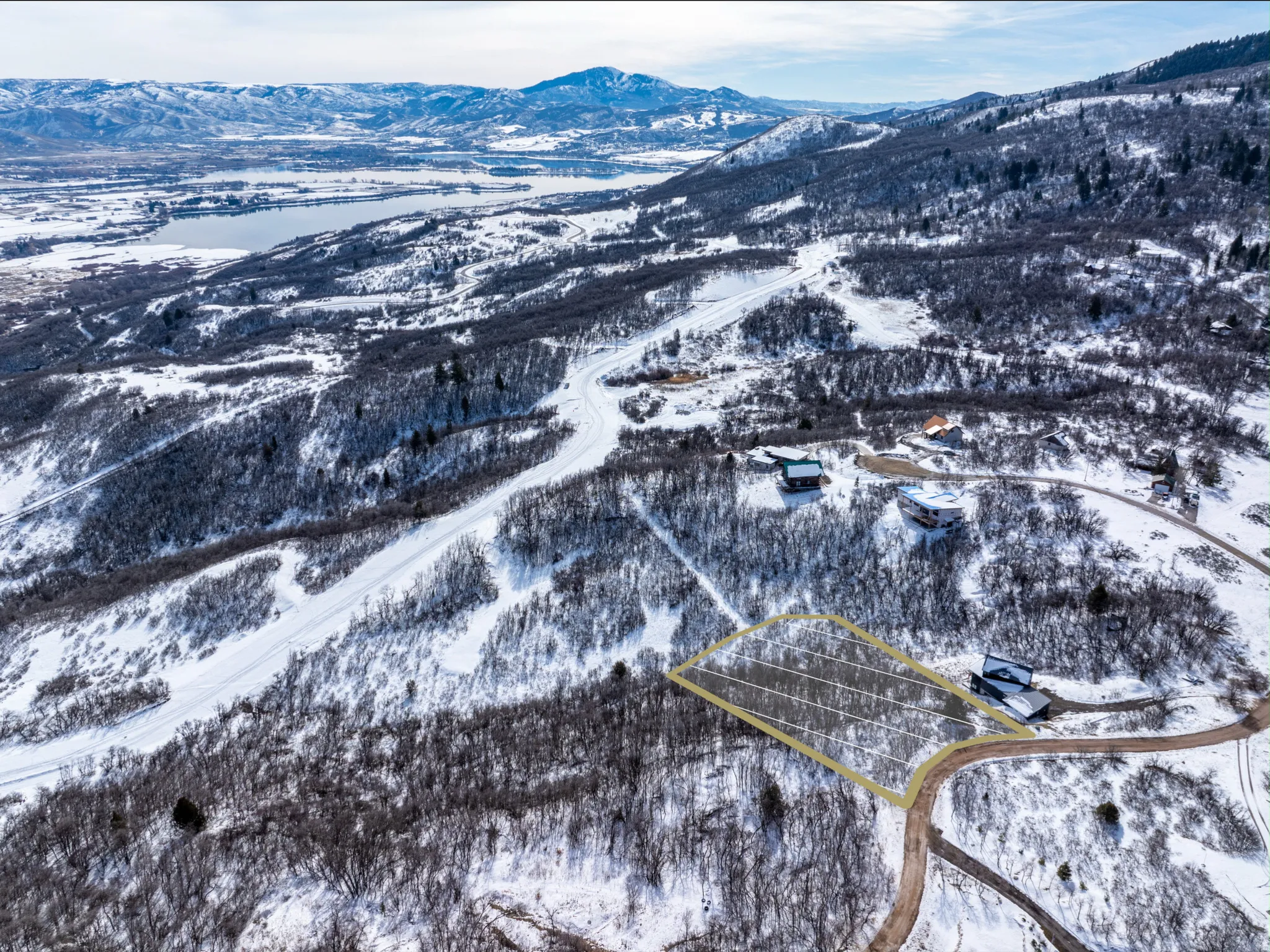 Snow-covered mountain landscape with a highlighted property outline