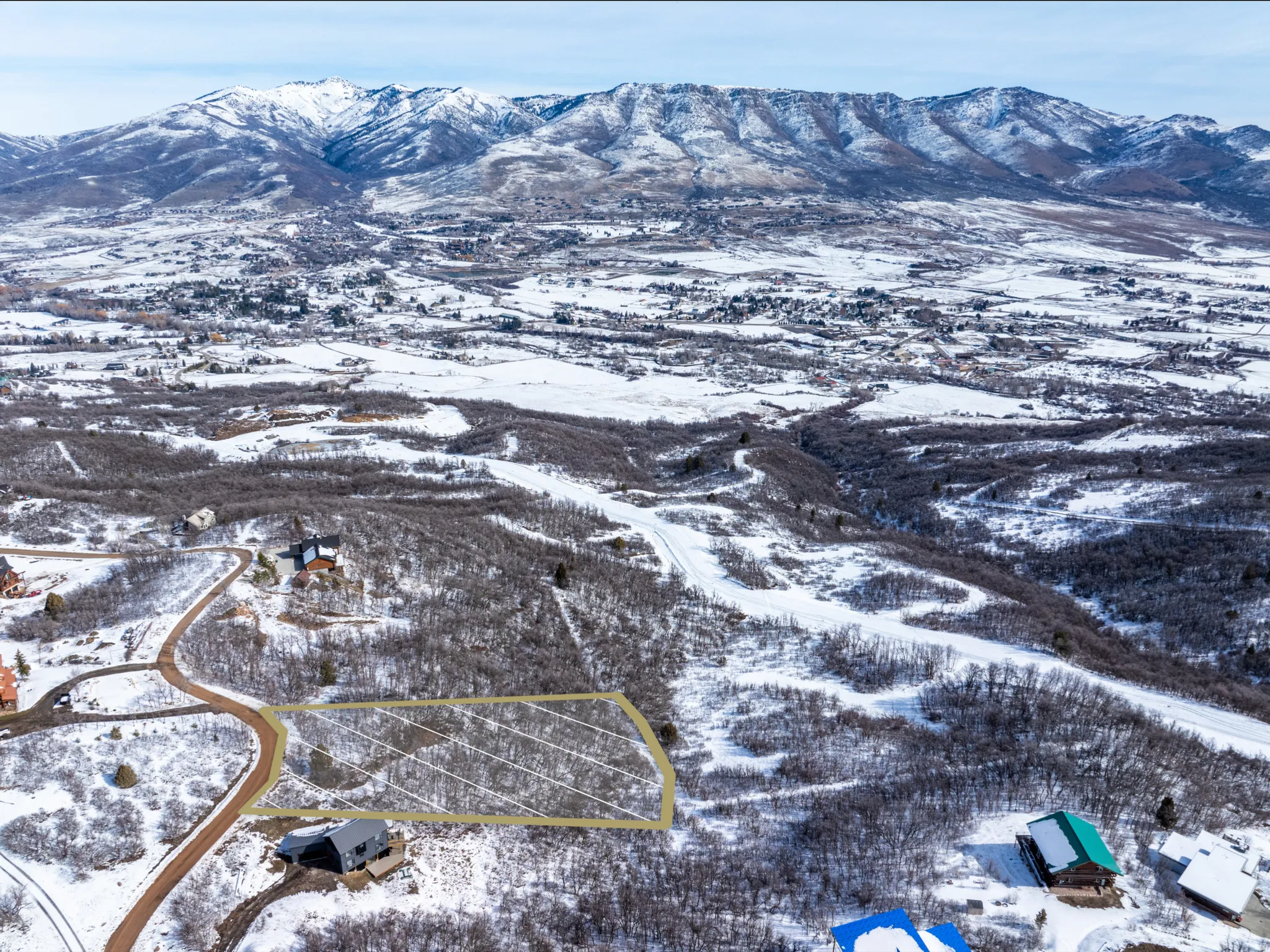 Expansive snow-covered landscape with a prominent mountain range backdrop