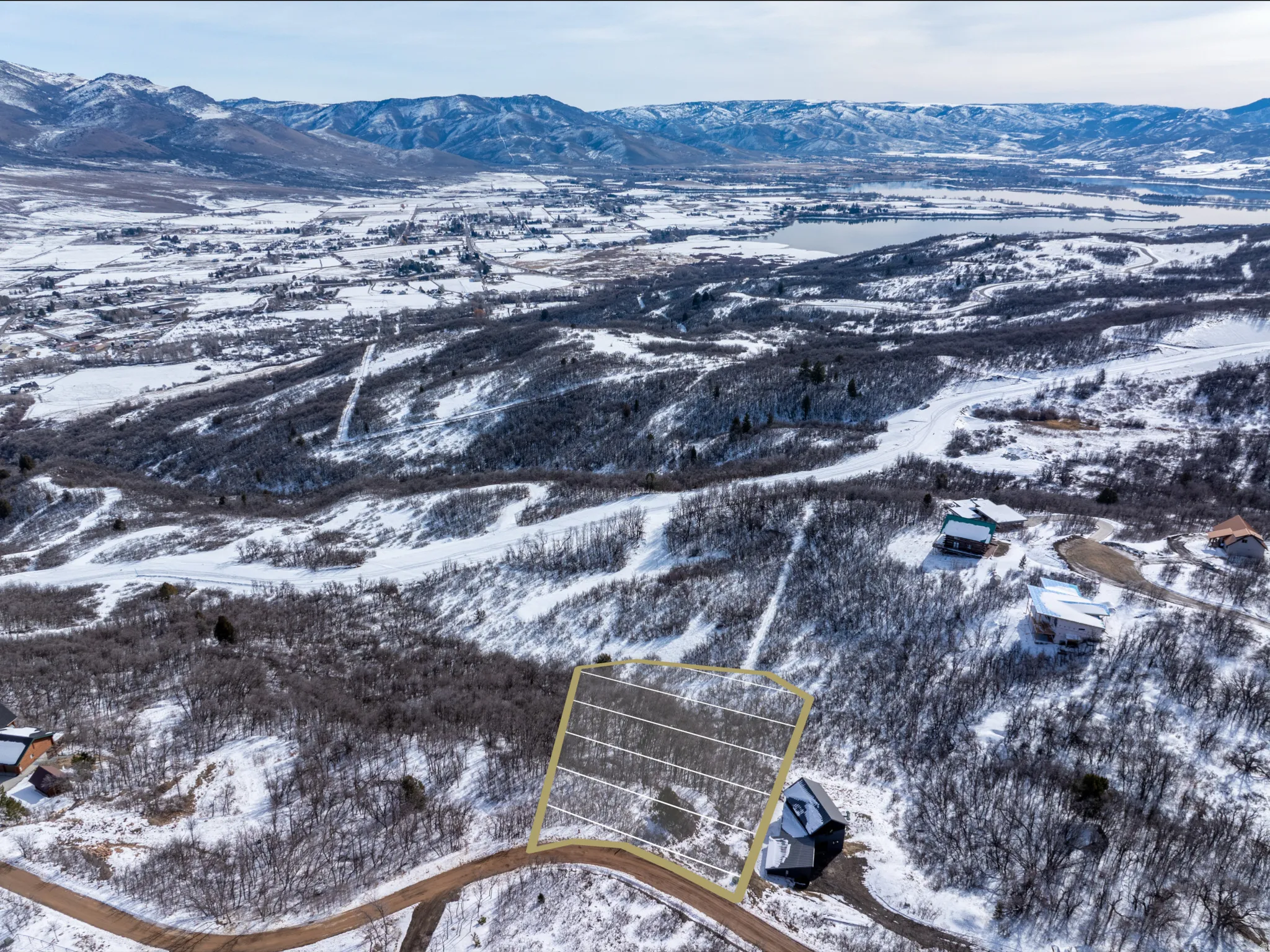 Expansive lot outlined in yellow, situated on a snow-covered mountain slope