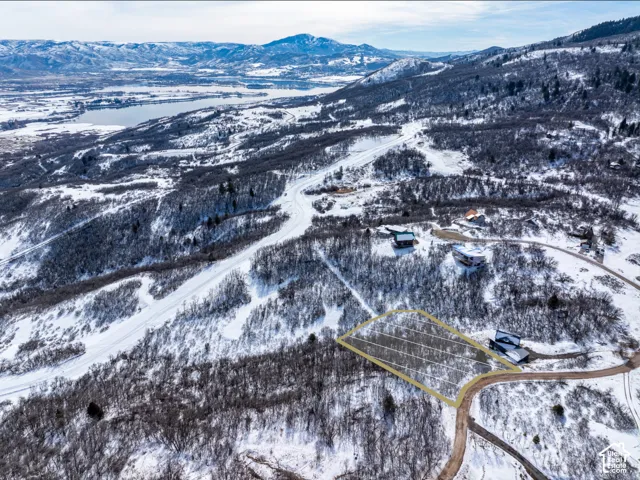 Snow-covered mountain landscape with a highlighted property outline