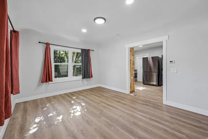 Wood-finish flooring, recessed lighting, and a window with exterior views