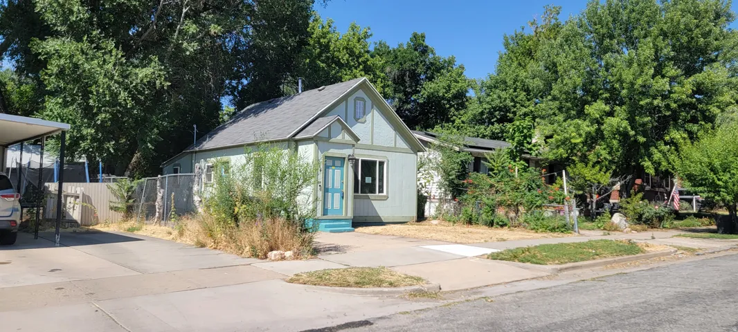 Gabled facade with a light blue door and white trim