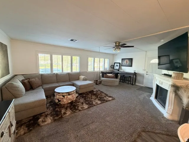 Living area featuring neutral-toned carpeting and wood-finish flooring