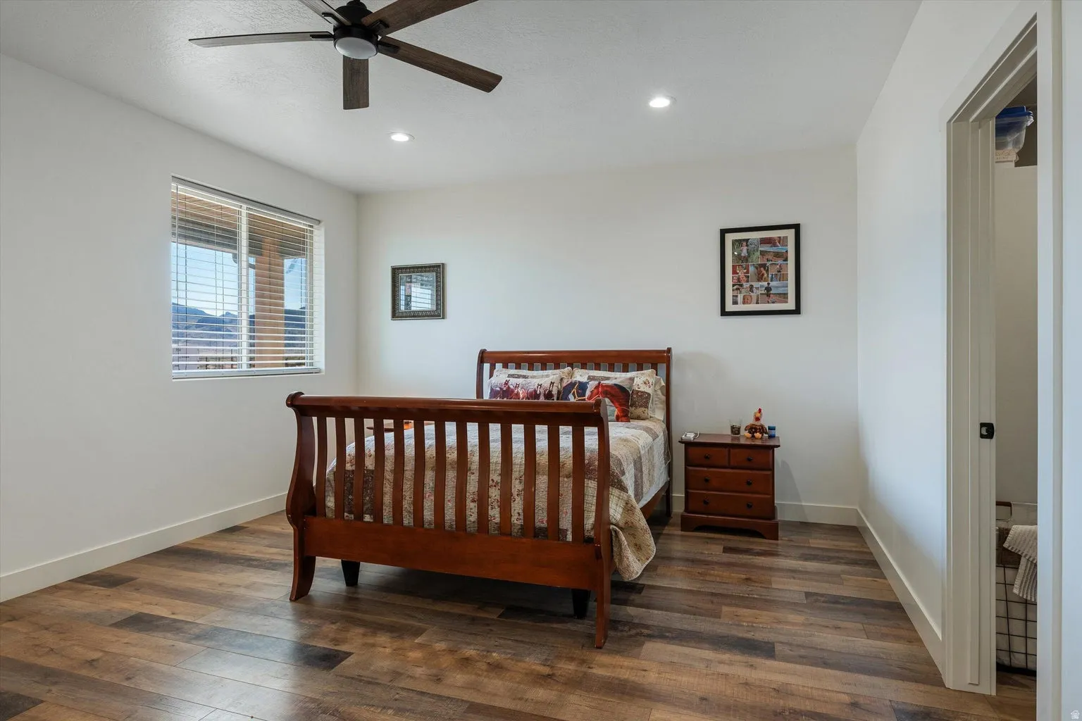 Spacious room featuring wood-finish flooring, a ceiling fan with integrated lighting, and recessed ceiling lights