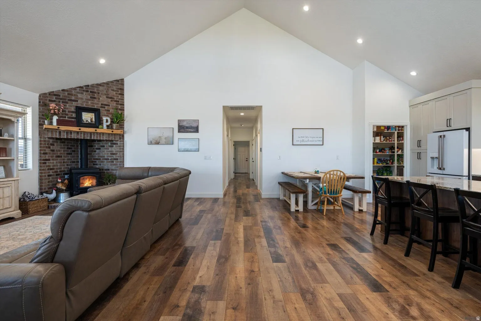 Vaulted ceilings enhance this open-concept living space, featuring wood-finish flooring throughout