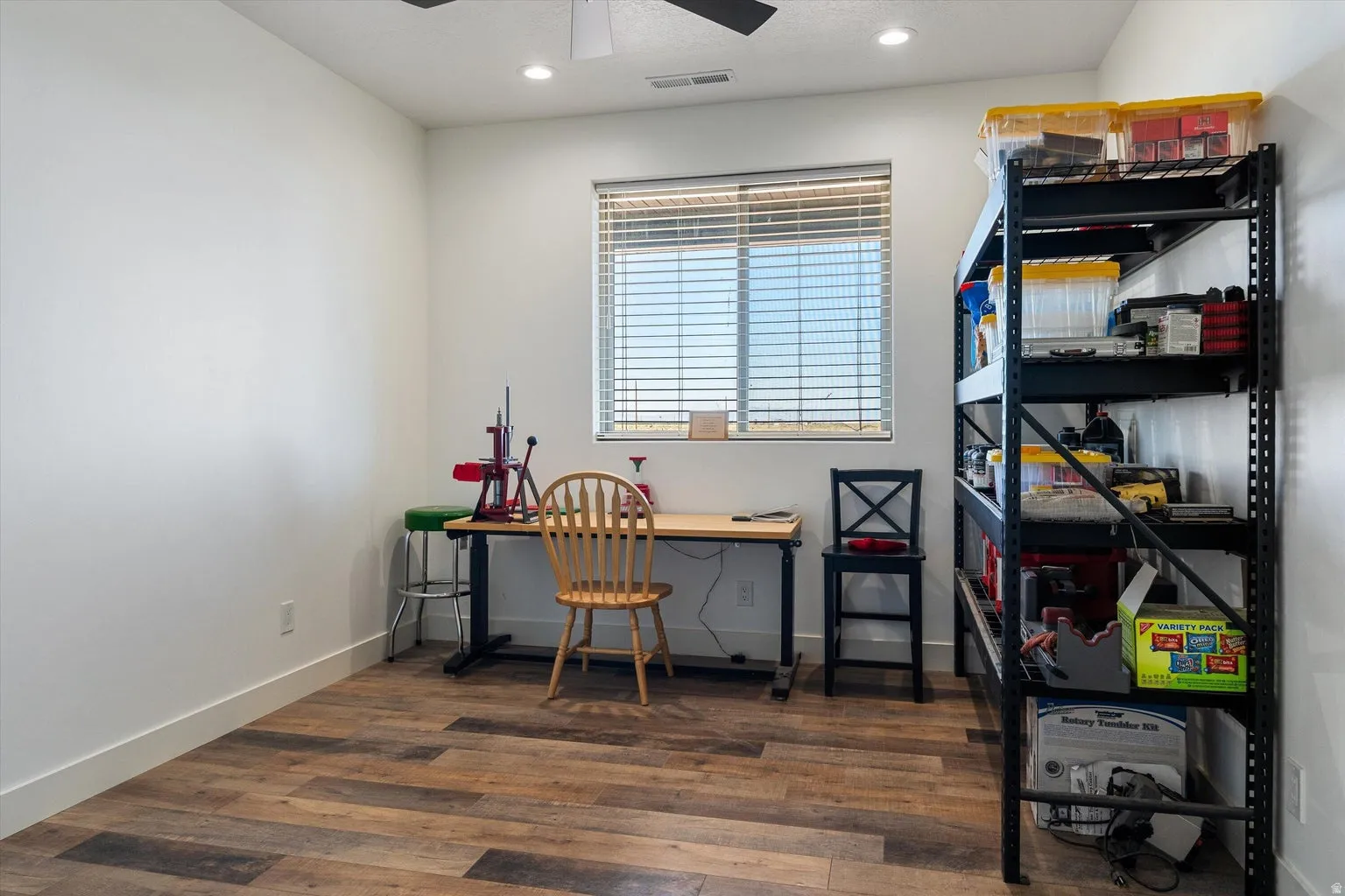 Versatile room featuring wood-finish flooring, recessed lighting, and a ceiling fan