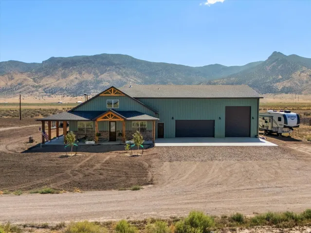 Custom-built residence featuring a covered front porch with exposed wood beams and stone accents