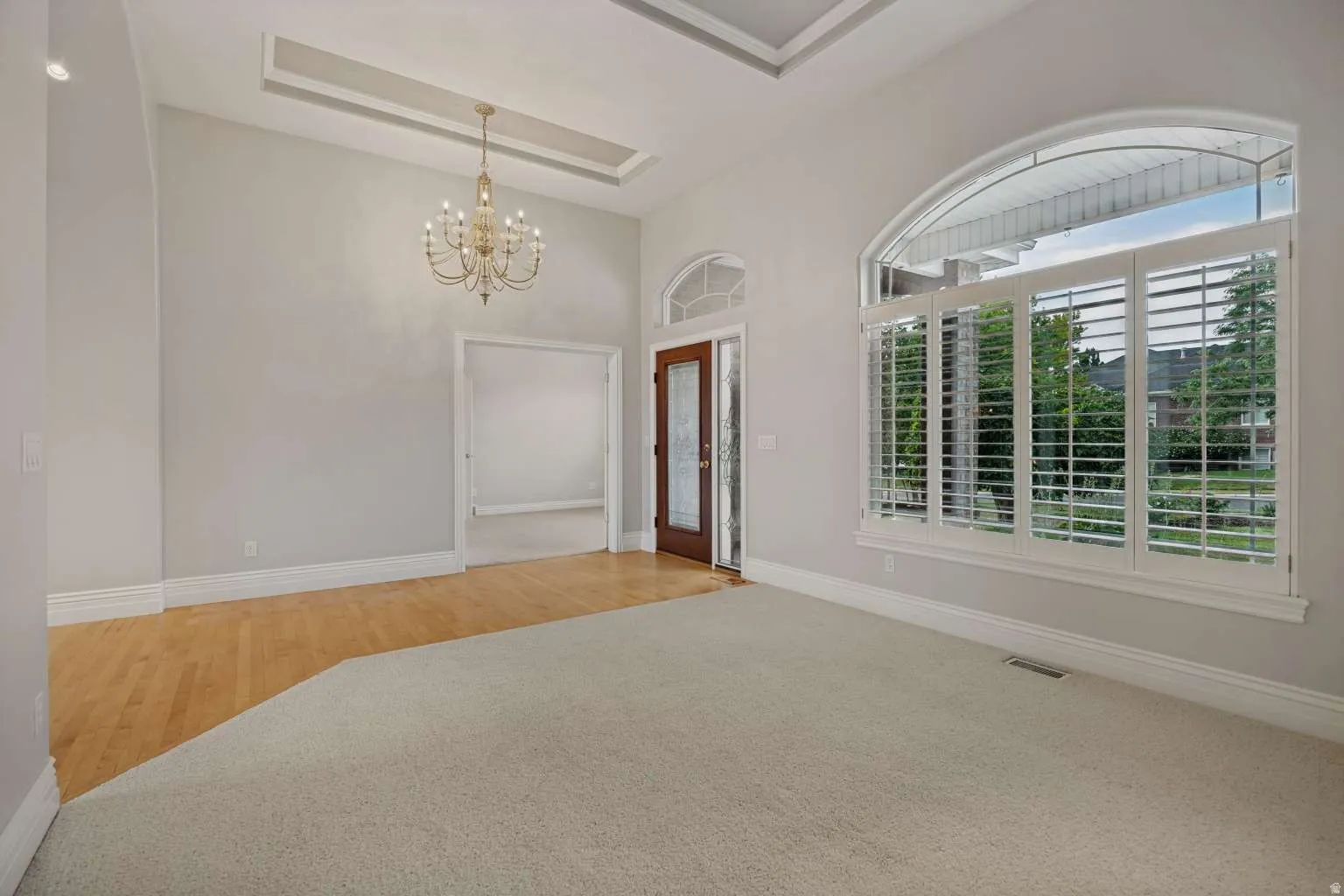 Arched transom window with plantation shutters