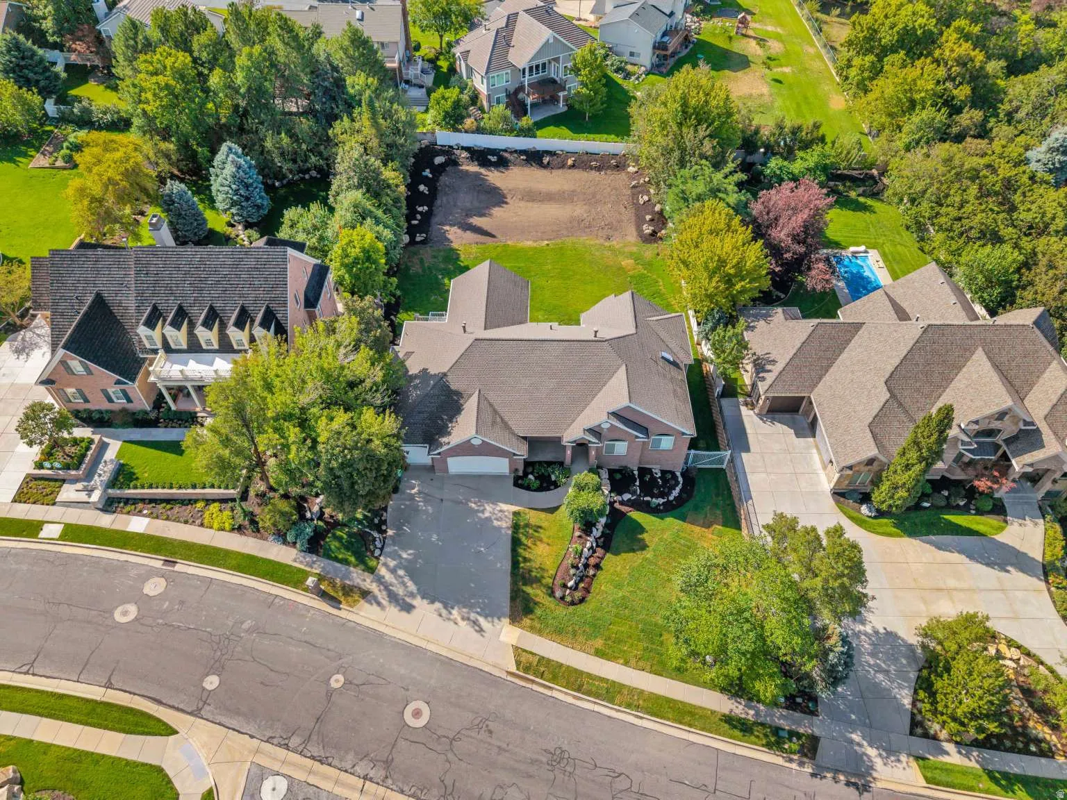Brick exterior residence with a multi-gabled roofline and an attached garage