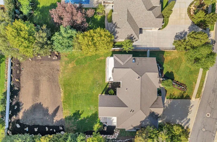 Expansive property featuring a large backyard with a prepared area, established lawn, and mature perimeter trees
