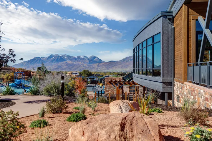 Modern architectural design featuring expansive windows, wood-finish siding, and stone accents