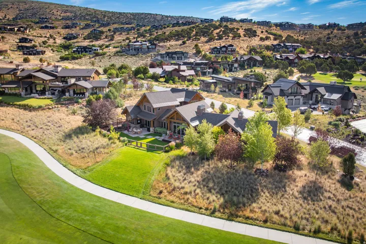 Hillside community featuring diverse architectural styles, mature landscaping, and golf course frontage