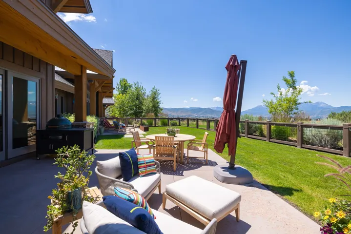 Expansive concrete patio offering open-air living space and mountain scenery