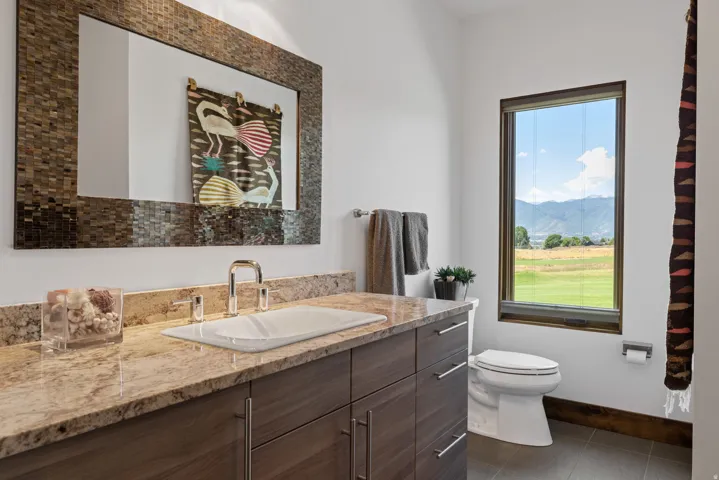 Modern vanity featuring an integrated sink, polished chrome faucet, and substantial countertop