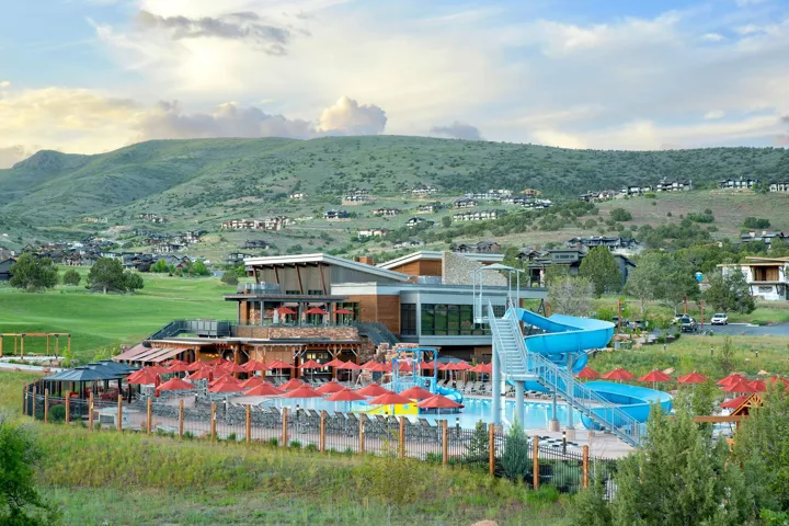 Community clubhouse with multiple pools and water slide