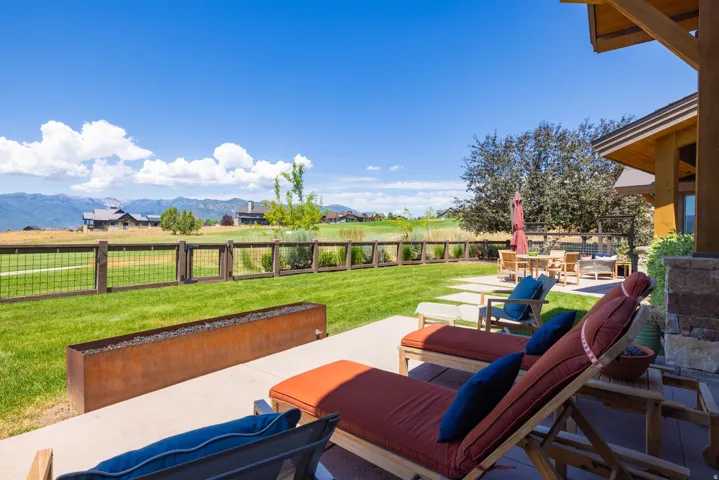 Expansive outdoor patio with concrete paving and a built-in fire feature