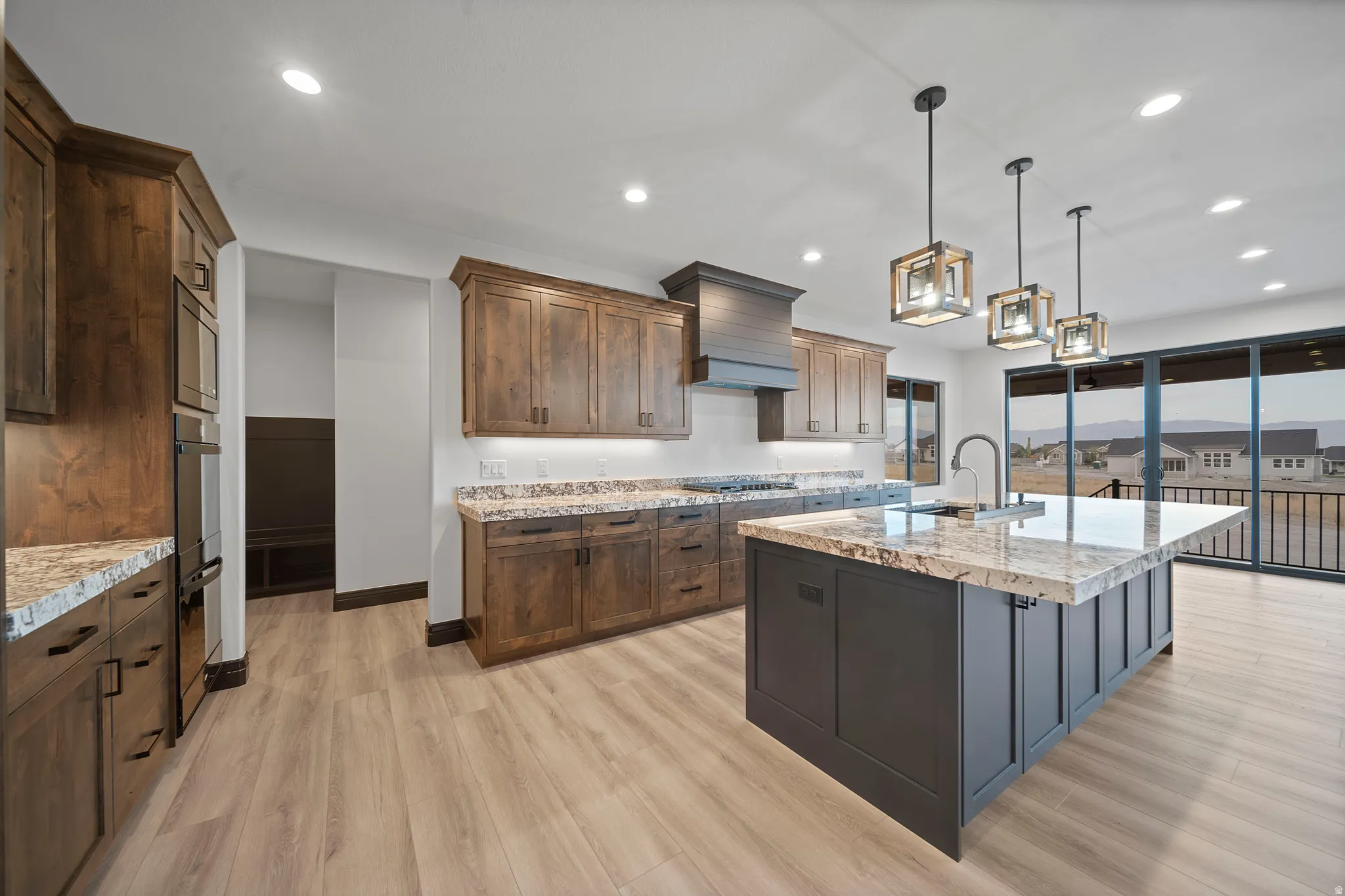 Modern kitchen featuring light wood-finish flooring and recessed lighting