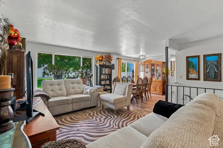Wood-finish flooring extends through the living area and into the dining space