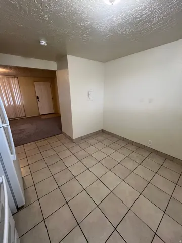 Dining area featuring ceramic tile flooring, neutral wall tones, and overhead lighting