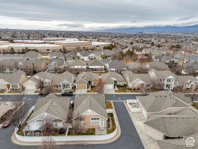 Residential area featuring a variety of single-family homes, mountain backdrop, and commercial structures in the distance