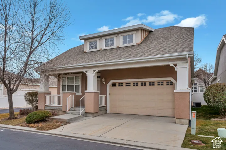Stucco exterior with a covered porch and dormer windows