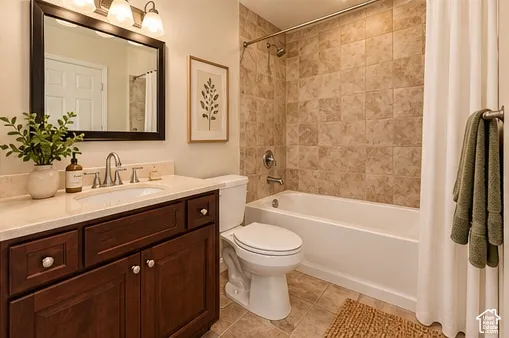 Spa-inspired bathroom featuring a wood-finish vanity with dual-sink quartz countertop, brushed nickel fixtures, and recessed lighting