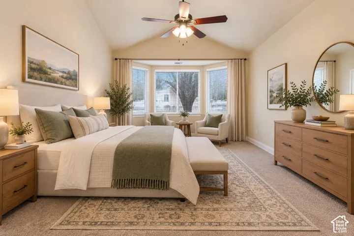 Primary bedroom suite featuring a bay window arrangement with multiple panes, ceiling fan with integrated lighting, wood-finish dresser and nightstands, and a geometric patterned area rug anchoring the space