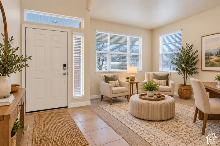 Entryway featuring a white paneled door with transom window and sidelight