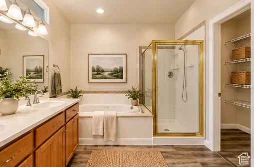 Spa-inspired primary bathroom showcasing a wood-finish vanity with dual sinks, quartz countertop, and polished chrome fixtures