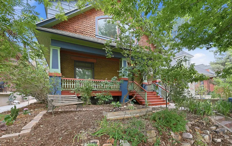 Brick facade home with a covered front porch featuring white railings