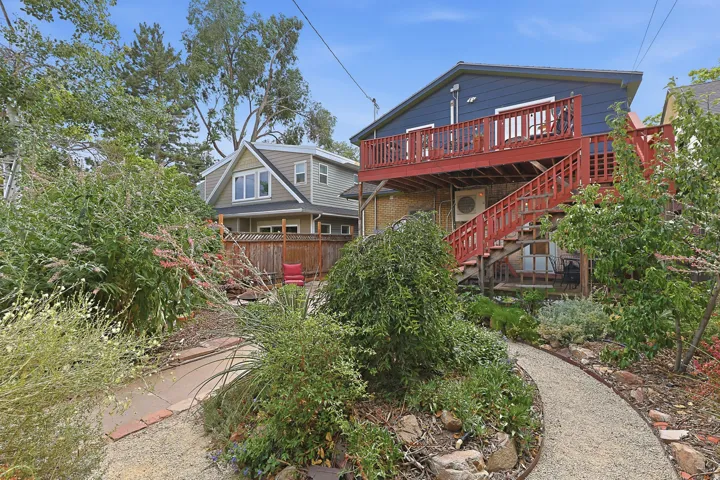 Multi-level deck with red railing system and exterior staircase