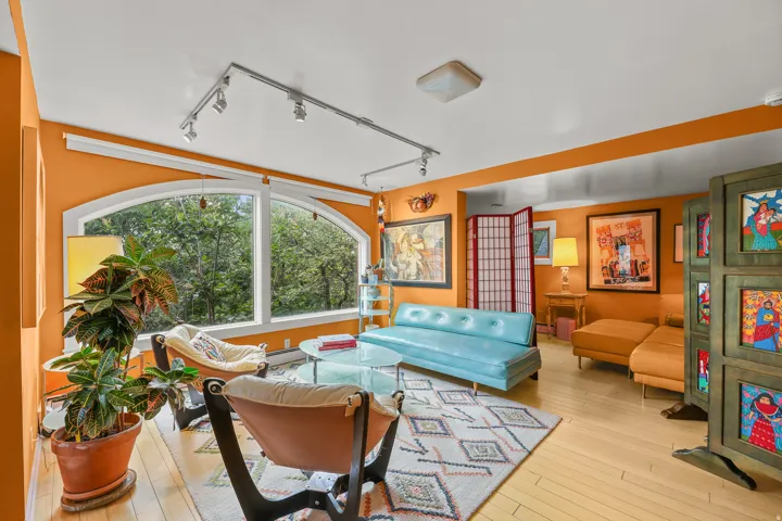 Arch-top window framing a verdant outdoor landscape
