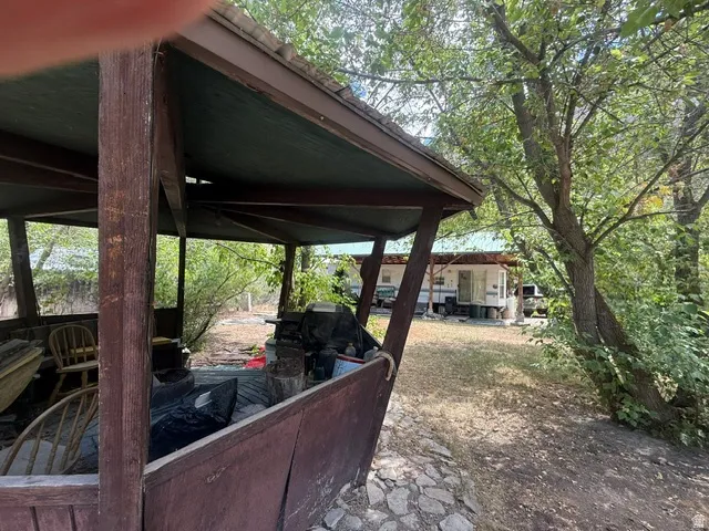 Wood-framed outdoor structure with a dark-stained finish and an overhanging roof