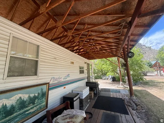 Extended covered wood deck with structural wood beams