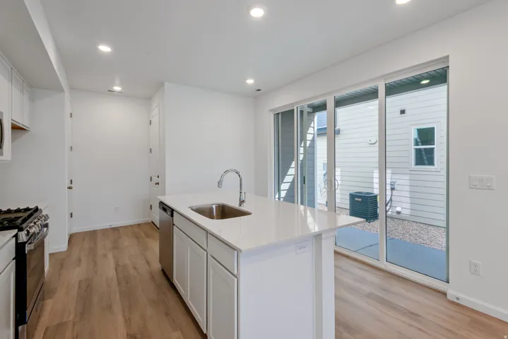 Contemporary kitchen featuring a spacious island with an undermount sink and gooseneck faucet
