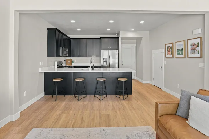 Open-concept living space with wood-finish flooring