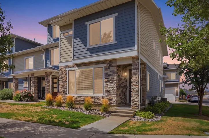 Modern townhome exterior featuring stone veneer accents and horizontal siding