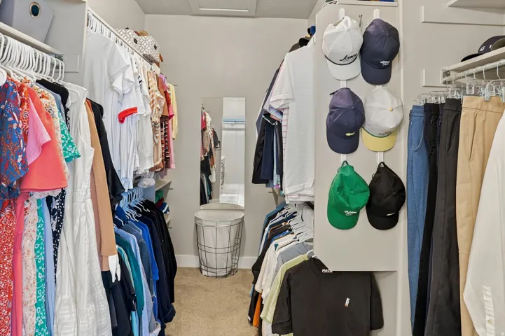 Walk-in closet featuring extensive shelving and hanging rods