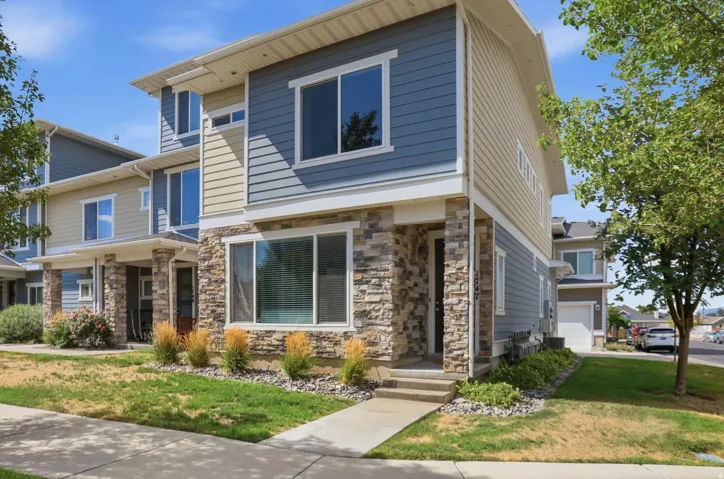 Multi-level exterior featuring stone veneer and horizontal siding