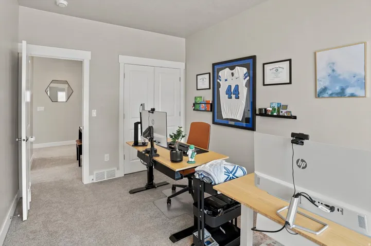 Carpeted room with light neutral wall paint, white trim, and a double-door closet