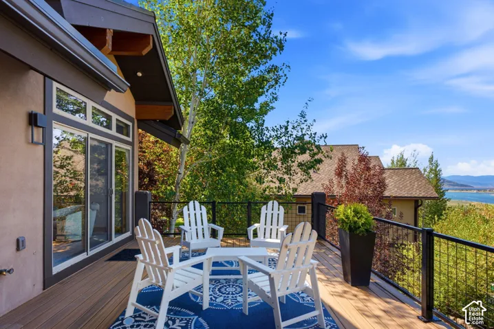Expansive outdoor deck featuring wood-finish flooring and a black metal railing system