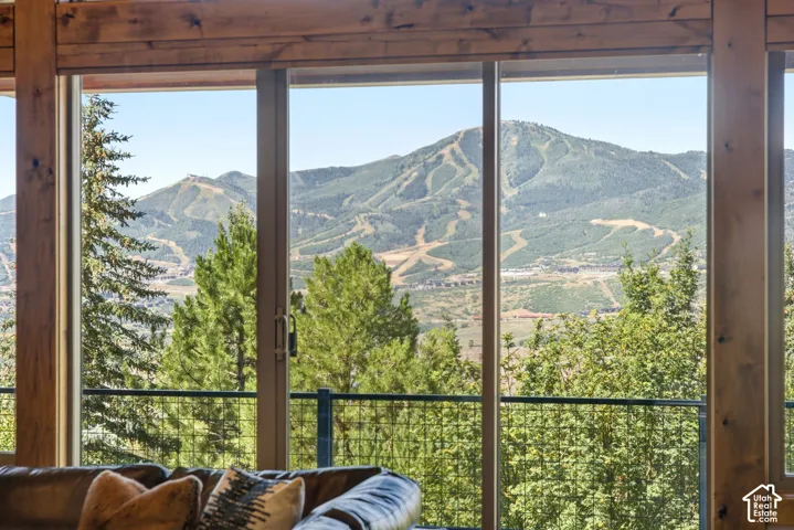 Expansive sliding glass doors provide mountain scenery