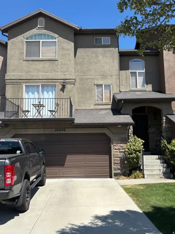 Stucco exterior with stone accents and a two-car garage