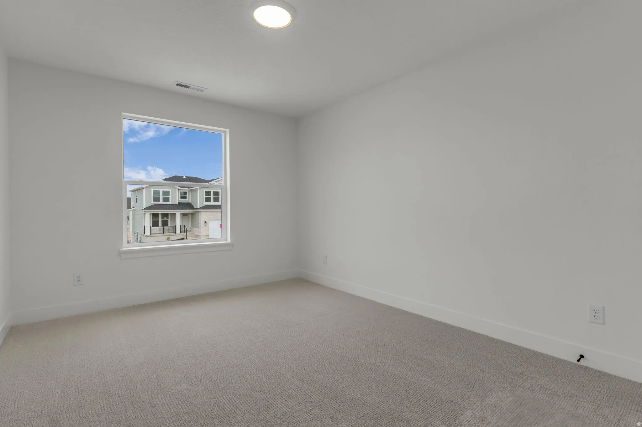 Spacious bedroom featuring oversized window.