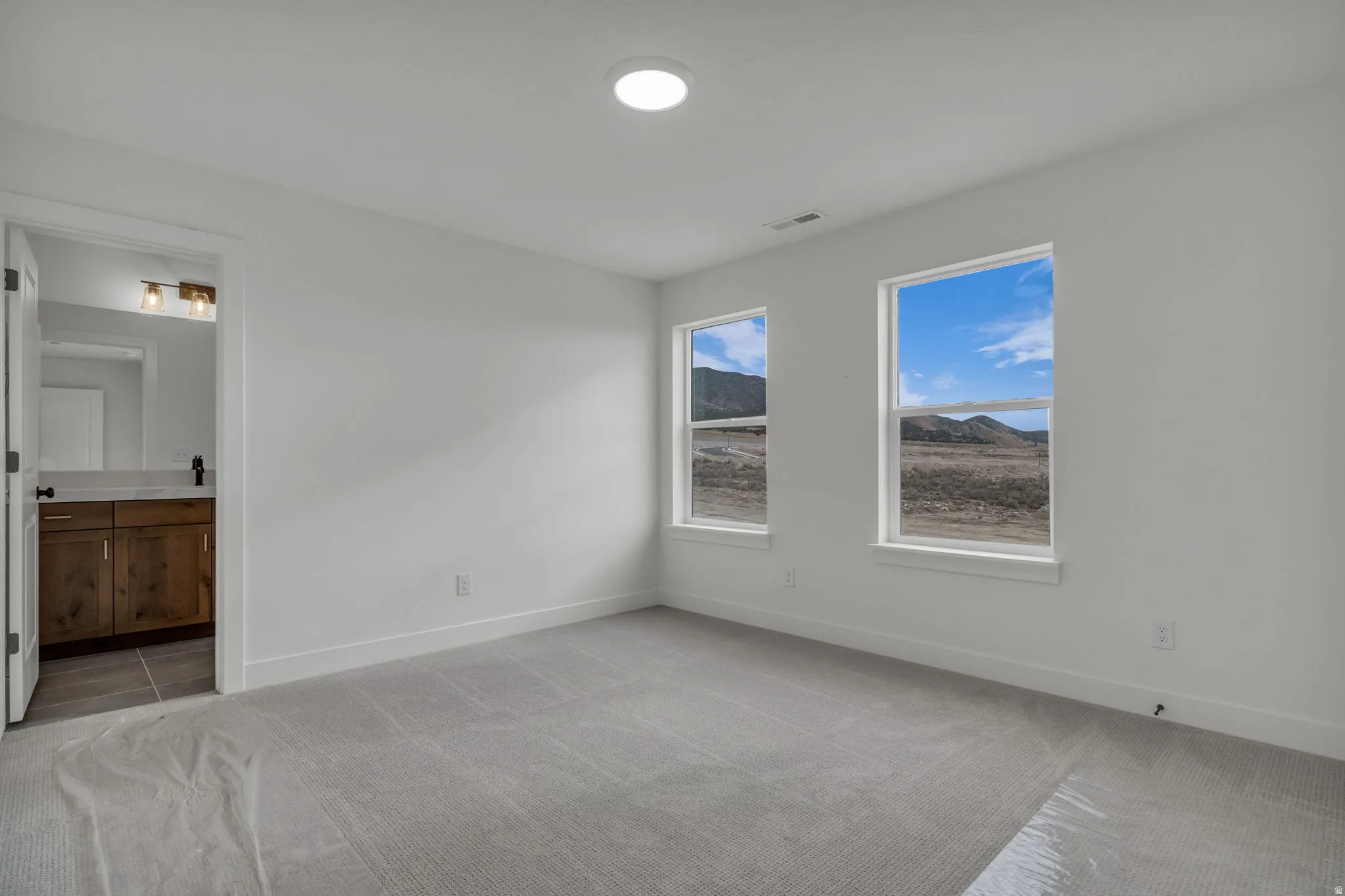 Large guest suite with attached full bath with beautiful mountain views.