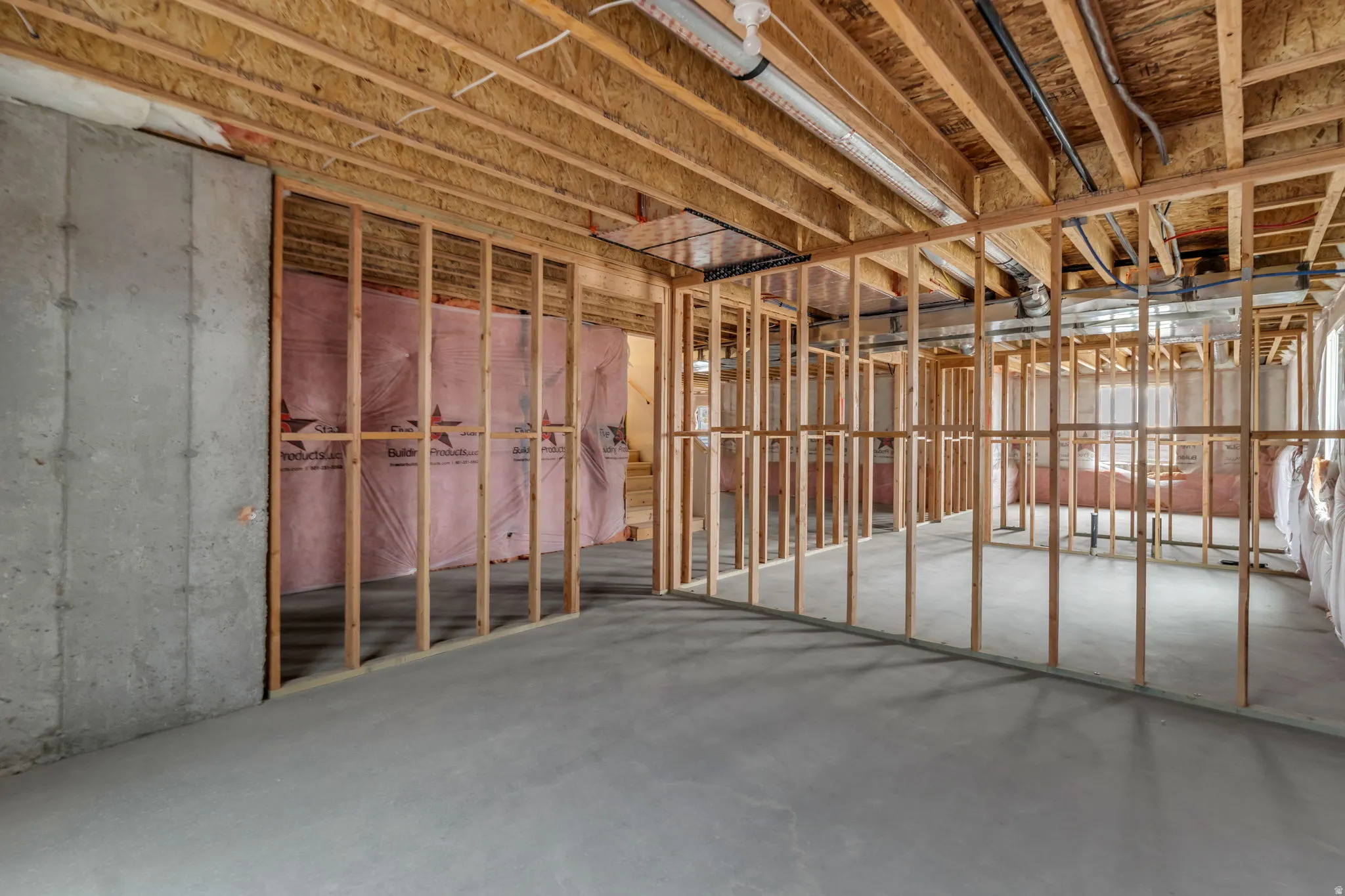 Unfinished basement with 9 foot ceilings throughout, partially framed.