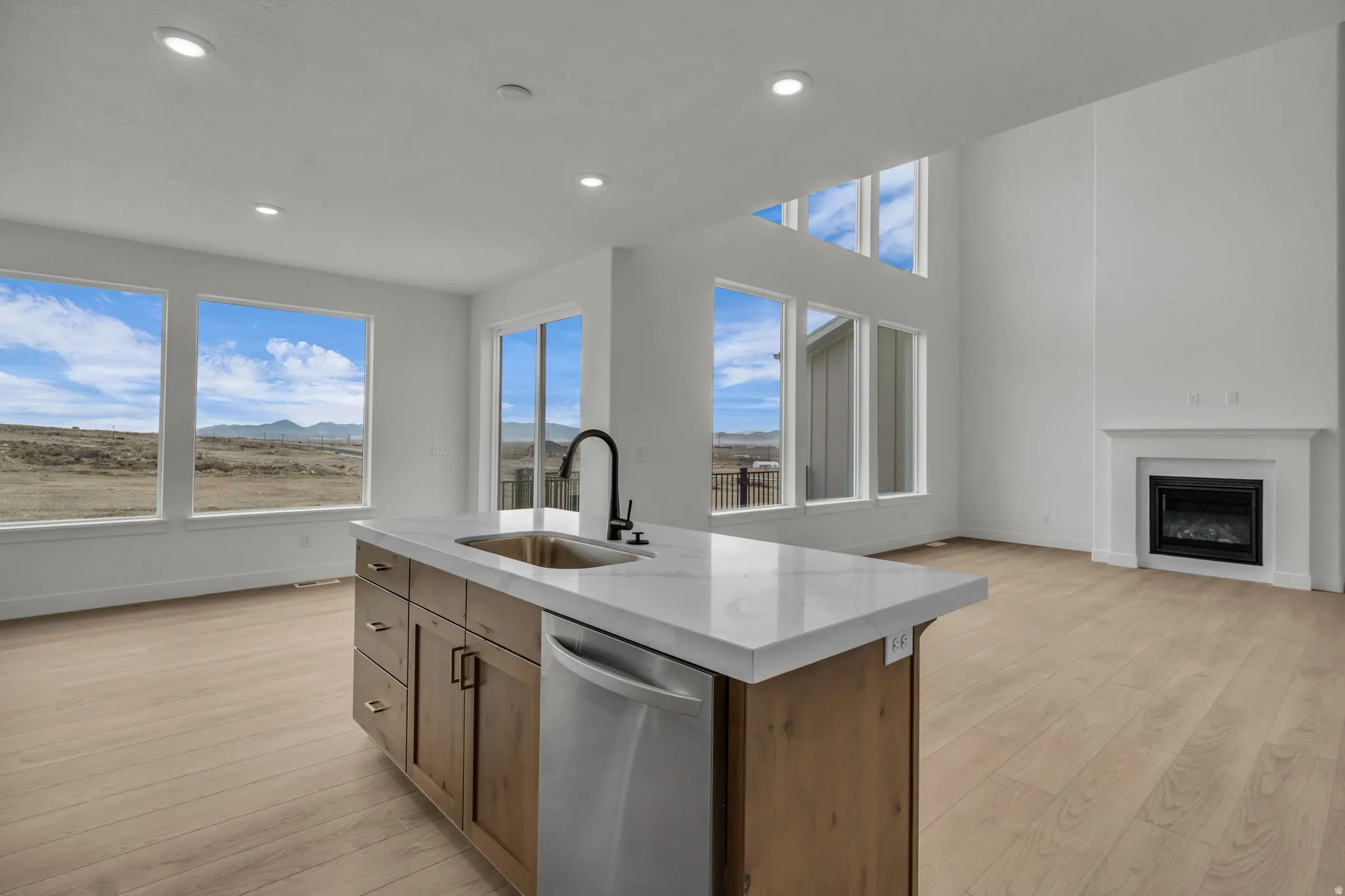 Great room, open concept with kitchen, dining and hosting areas in a beautiful two story space with oversized custom windows