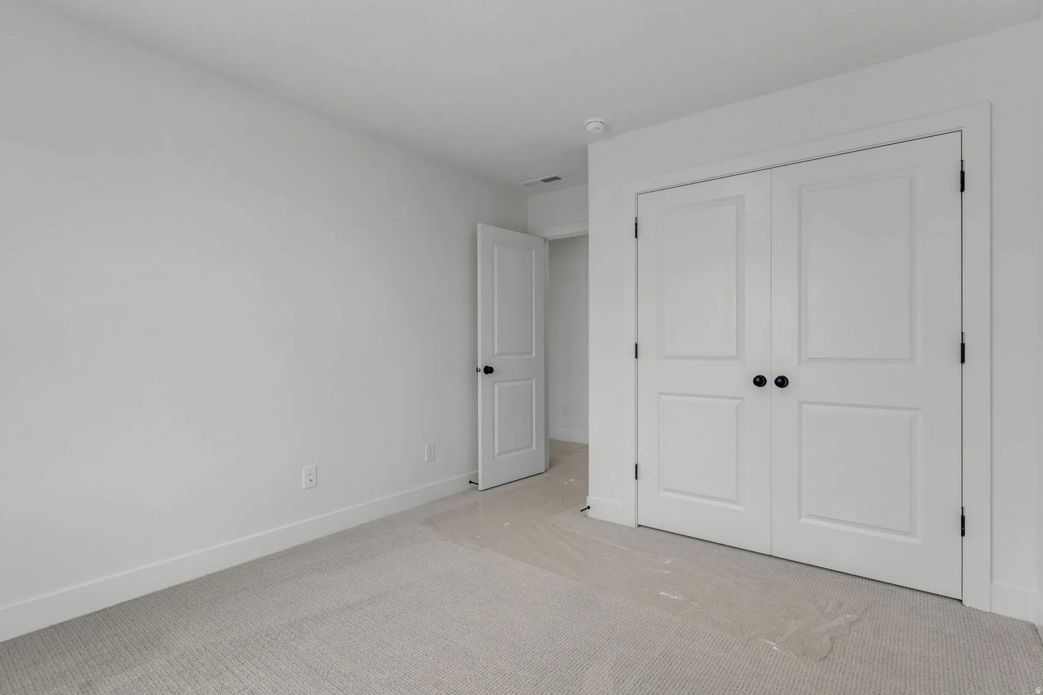 Bedroom featuring generous double door closet.