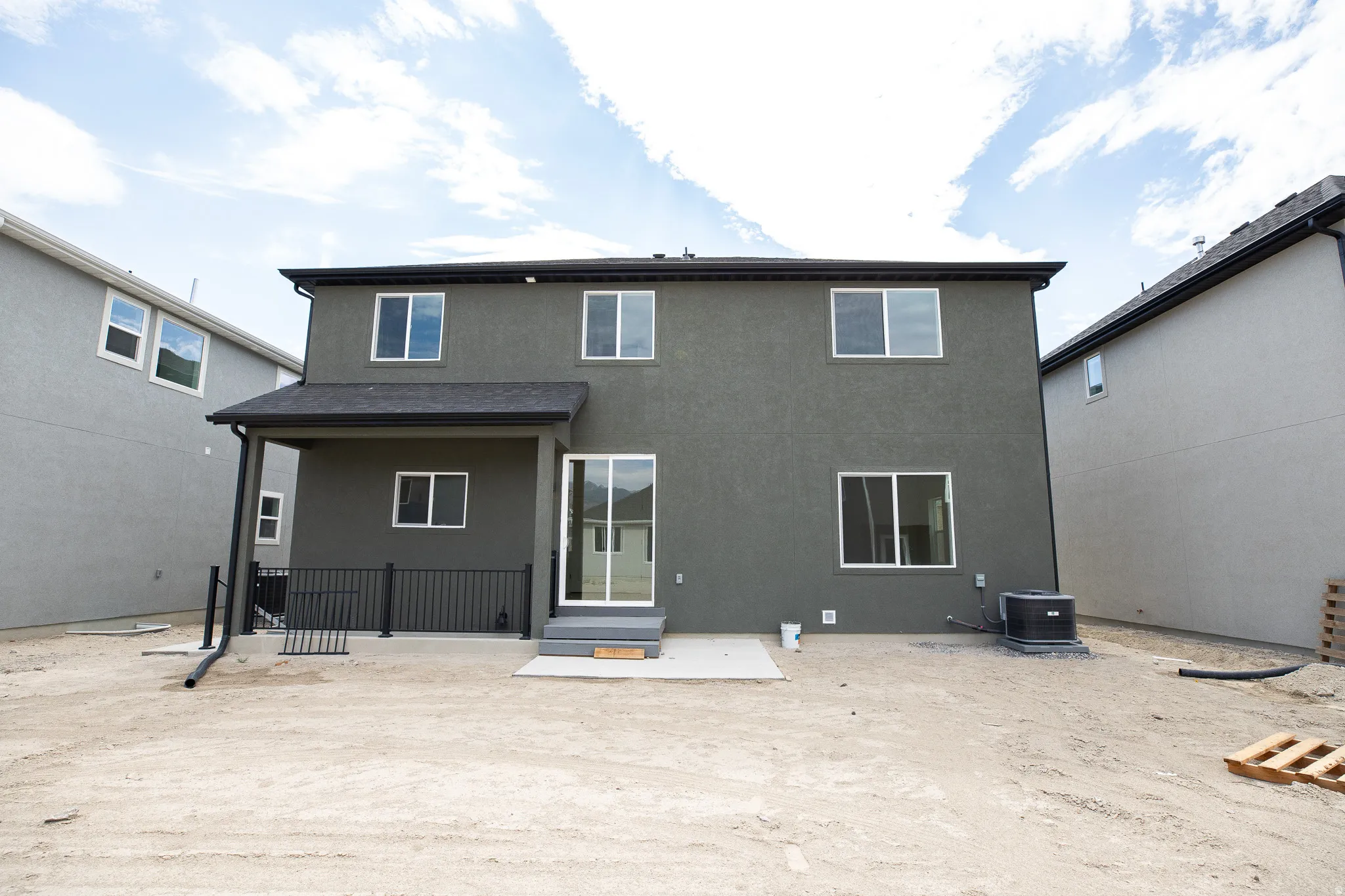 Rear view of Redwood with exterior basement entrance for ADU in basement.