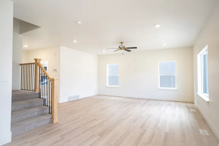 Family room with 9' ceiling and ceiling fan.